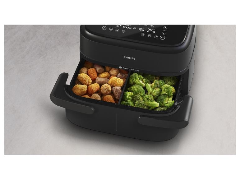 Schwarze Philips Heißluftfritteuse mit zwei Körben voller Brokkoli und Kroketten.