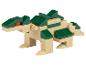 Beiges und grünes Dinosaurier-Bausteinspielzeug auf weißem Hintergrund.