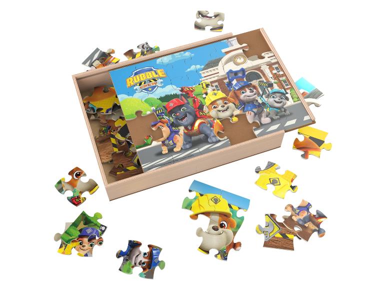 Holzpuzzle mit Welpen und „Rubble & Crew“-Text in einer Holzkiste.