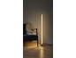 LED-Stehlampe mit Luftblasen neben einem Sessel mit Decke und Buch.