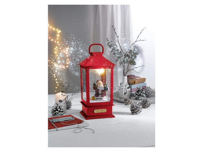 Rote Weihnachtslaterne mit einer Weihnachtsmannfigur.