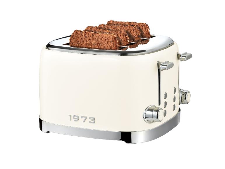 Cremefarbener Toaster mit vier Scheiben dunklem Brot und der Aufschrift „1973“.