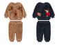 Zwei Sets Babykleidung mit Rentier- und Hundedesigns, mit weicher, plüschiger Textur.