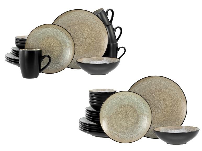 Schwarz-beiges Steingut-Geschirrset mit Tellern, Schalen und Tassen.