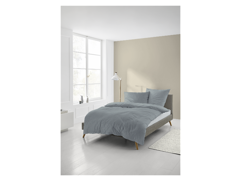 Hellblaue Bettwäsche auf einem modernen Bett.