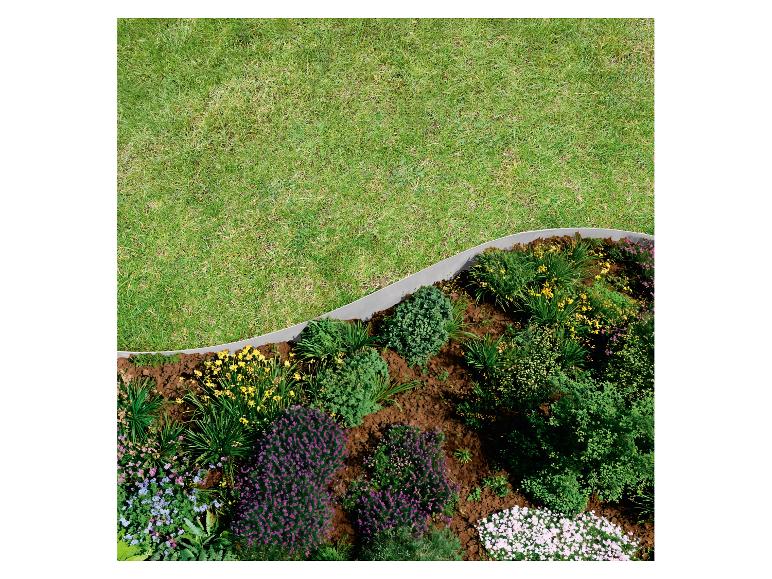 Gartenbeet mit Blumen und Sträuchern, durch eine Kante vom Rasen getrennt