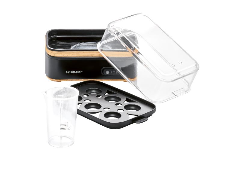 SilverCrest Eierkocher: Kochgerät, transparenter Deckel und Messbecher.