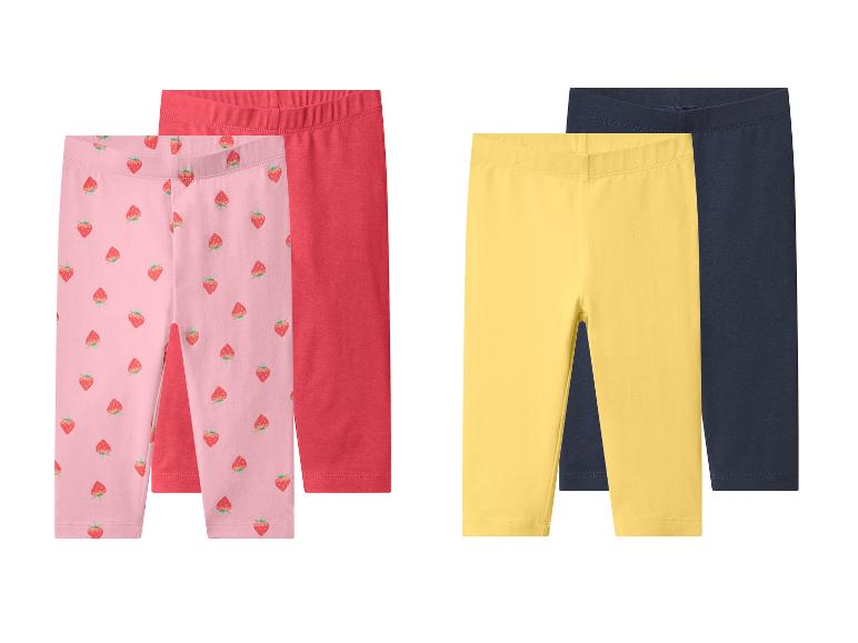 Set aus zwei Mädchen-Leggings: rosa mit Erdbeeren und rot, plus gelb und dunkelblau.