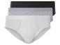 Drei Paar Boxershorts in Weiß, Grau und Schwarz.