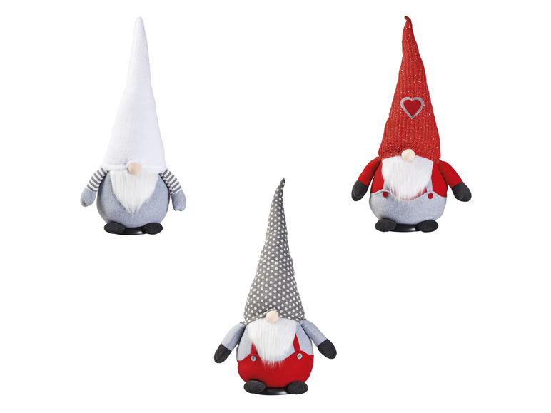 Drei Weihnachtswichtel mit weißen, roten und grauen Mützen.