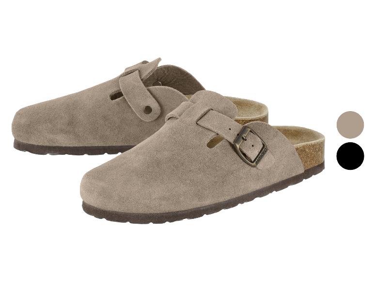 Zwei beige Wildleder-Clogs mit Schnallen, einer vor dem anderen.