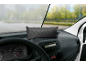Grauer Auto-Entfeuchter auf dem Armaturenbrett eines Fahrzeugs.
