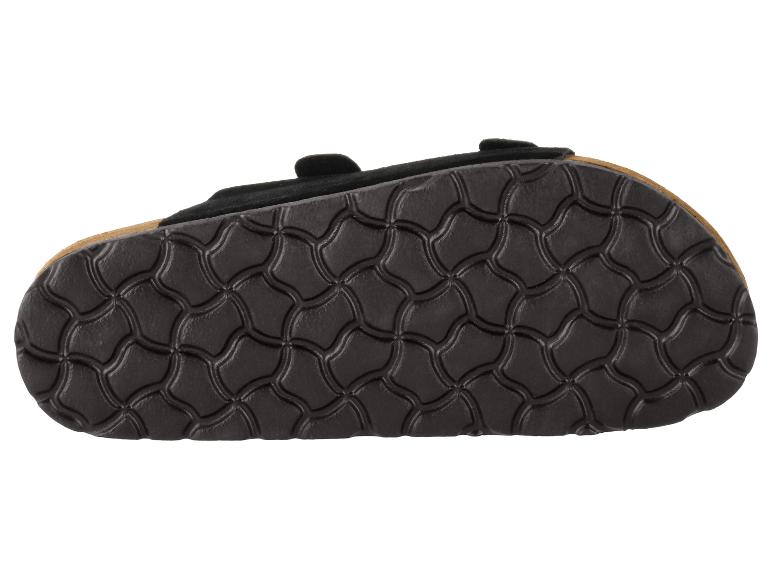 Schwarze strukturierte Sandalensohle mit Wellenmuster.