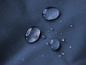 Wassertropfen auf einem blauen, wasserdichten Stoff.