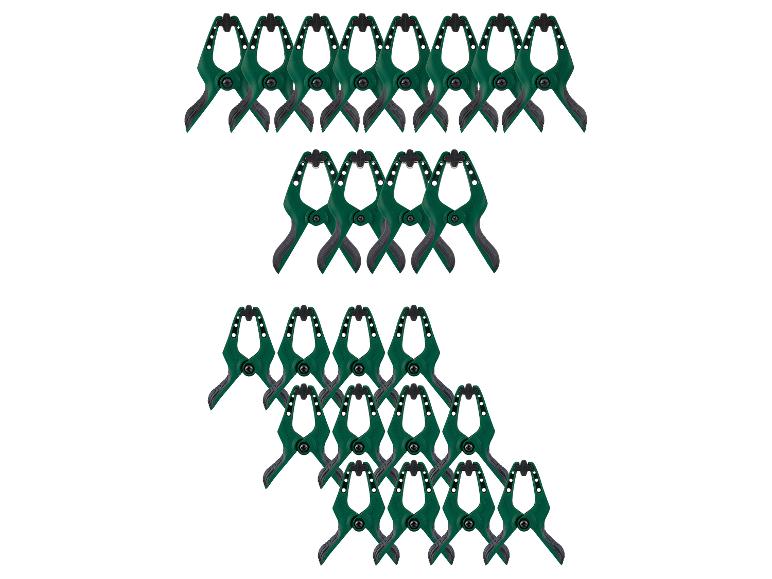 Grüne Federklemmen in Reihen auf weißem Hintergrund.