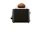 Ein schwarzer Toaster mit einer Scheibe Brot mit Sonnenblumenkernen