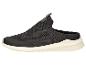 Schwarze Mesh-Slipper mit weißer Sohle und grünen Akzenten.