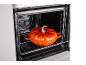 Backofen mit orangefarbenem Kürbis-Topf auf einem Rost