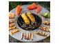 Runder Grill mit Maiskolben, Paprika, Lachs, Garnelenspießen und Würstchen.