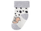 Weiße Babysocken mit Dumbo-Motiv und schwarzen Punkten.