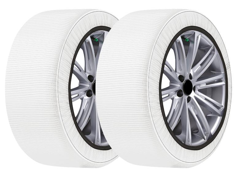 Zwei weiße Schneeketten für Reifen.