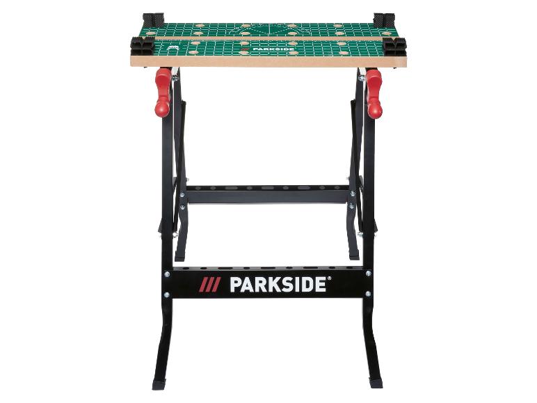 Klappbare Werkbank mit grüner und beiger Platte, mit Raster und Messmarkierungen.