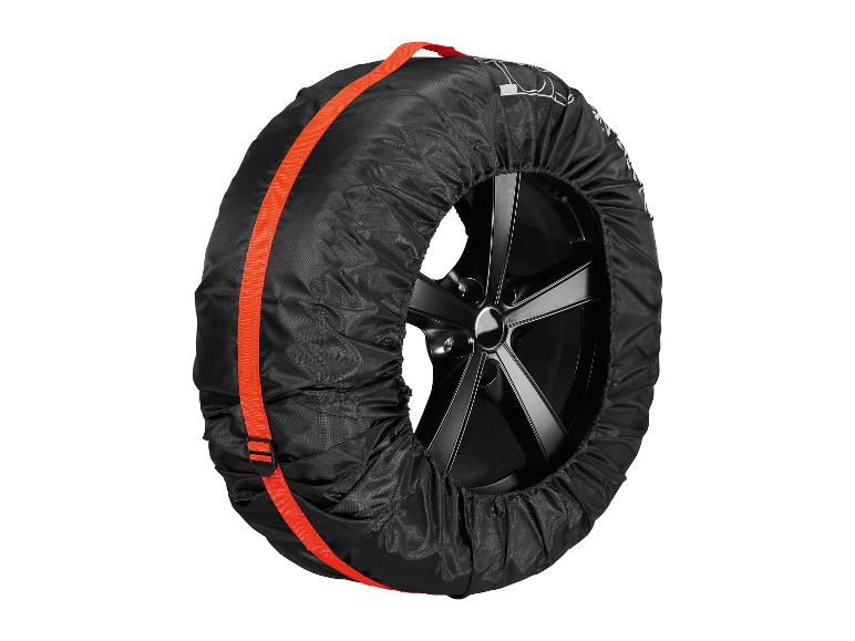 Eine schwarze Reifenhülle mit orangenen Gurten schützt einen Reifen mit schwarzen Felgen.