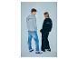 Mann und Frau in grauen und schwarzen Sweatshirts mit „STRENESSE BLUE“ und Jeans.