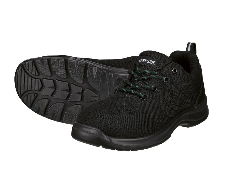 Schwarze Arbeitsschuhe mit grünen Schnürsenkeln und robuster Sohle