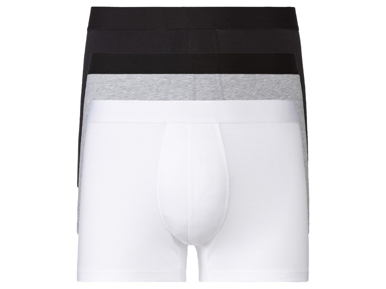 Drei Paar Boxershorts in Weiß, Grau und Schwarz.