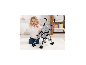 BAYER DESIGN Puppen-Buggy mit Tasche und ein spielendes Kind.