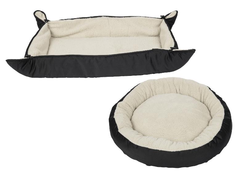 Zwei Haustierbetten, ein rechteckiges und ein rundes, beide schwarz mit cremefarbenem, flauschigem Innenfutter.