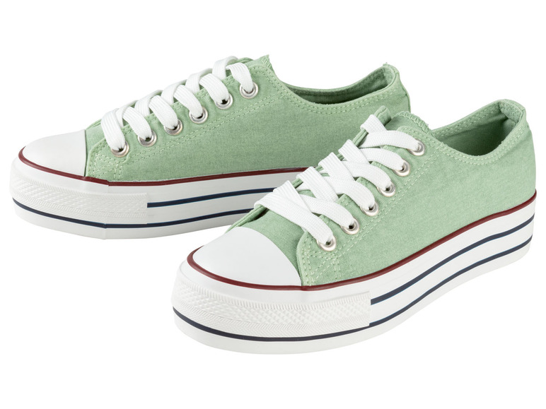 Zwei Paar grüne Canvas-Sneaker mit weißen Schnürsenkeln.