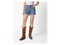 Frau trägt Jeans-Shorts und braune Westernstiefel.