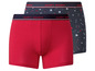 Zwei 'Happy Shorts' Boxershorts, eine rote unifarbene und eine blaue mit Herzchen-Print.