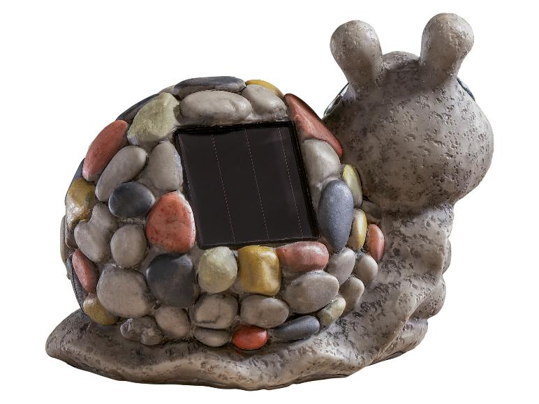 Eine schalenförmige, solarbetriebene Gartenleuchte in Schneckenform.