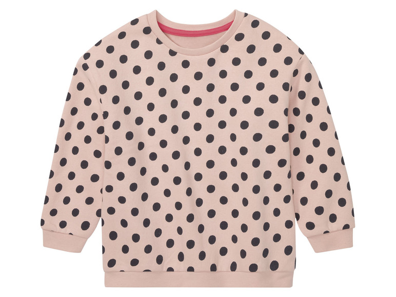 Ein rosa Pullover mit schwarzen Punkten.