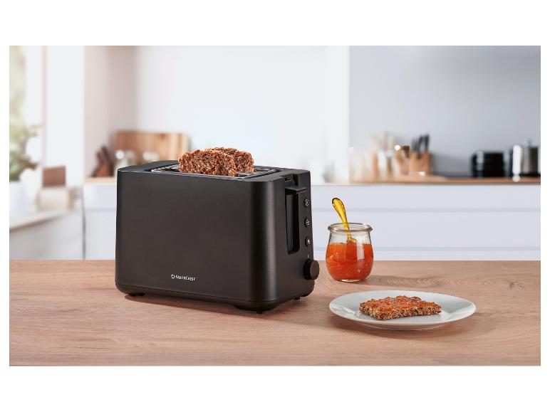 Schwarzer SilverCrest Toaster mit Toast und Marmelade in einer hellen Küche.