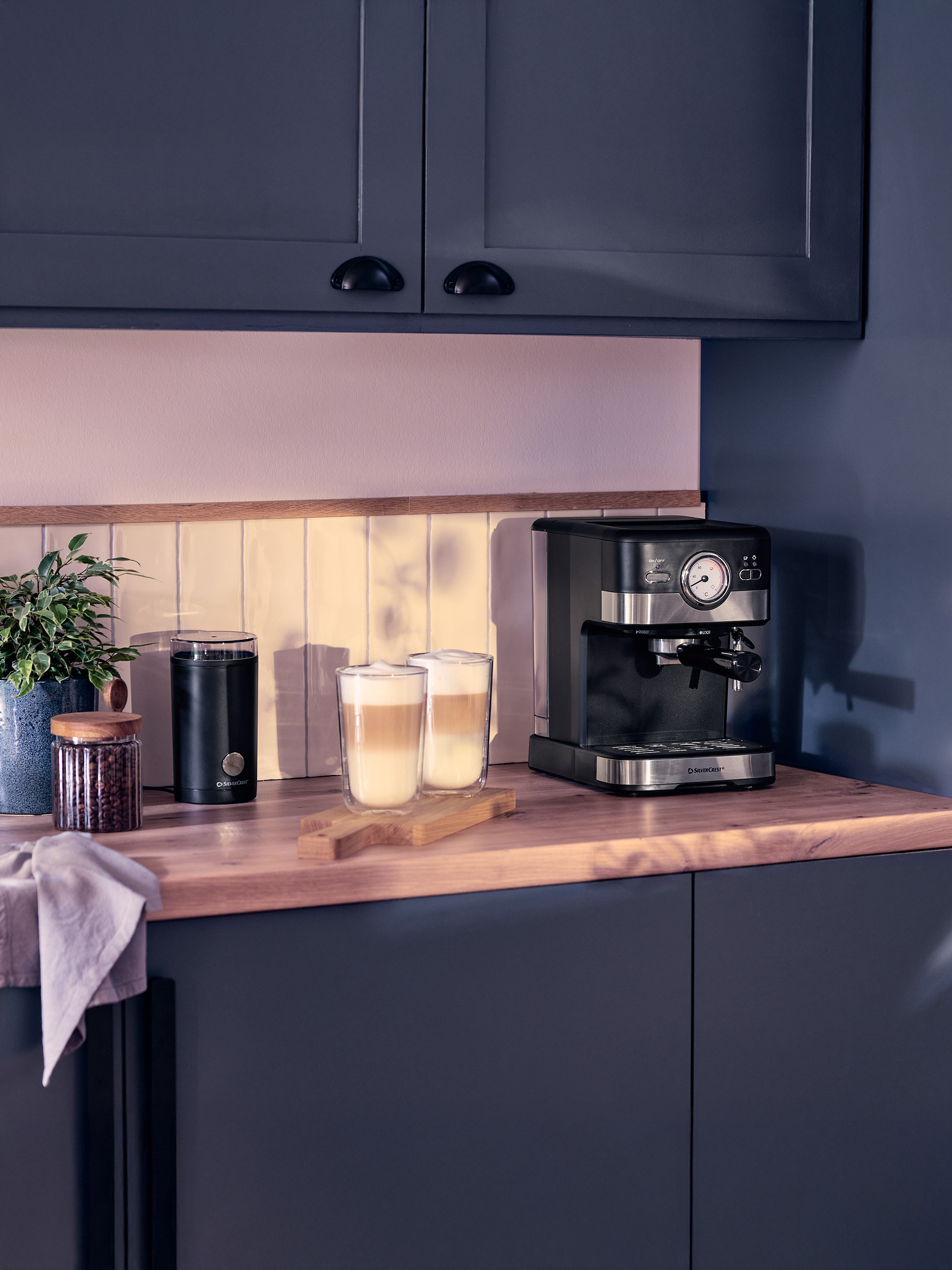 Kaffeemaschine und Mühle in einer modernen Küche mit Latte Macchiato.