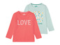 Zwei Lupilu Langarmshirts für Mädchen mit Blumenmuster und 'LOVE' Schriftzug.