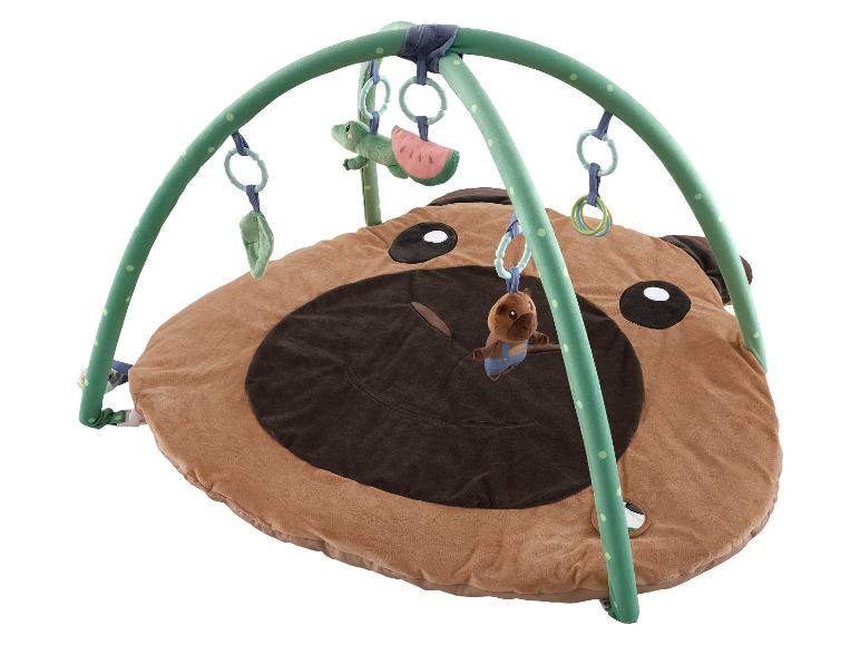Baby-Spieldecke in Form eines braunen Bären mit grünem Bogen und Hängespielzeug.