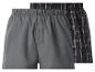 Zwei Boxershorts, eine graue und eine schwarz karierte.