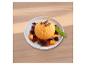 Mangosorbet mit Beeren, Mangostücken und Schokolade, garniert mit Minze.