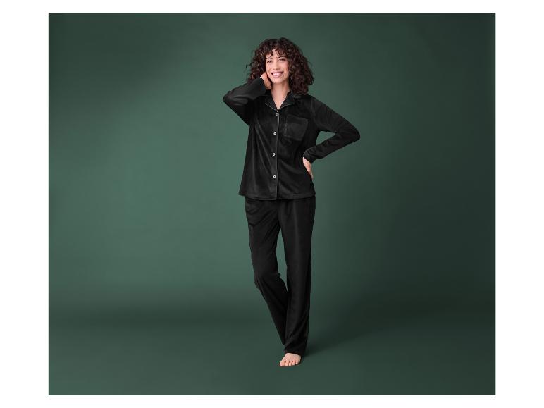 Eine Frau trägt einen schwarzen Samt-Pyjama.