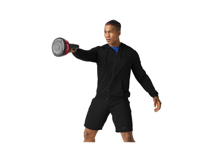 Mann in schwarzer Sportkleidung trainiert mit Gewichten.