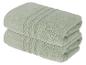 Zwei gefaltete hellgrüne Baumwollhandtücher