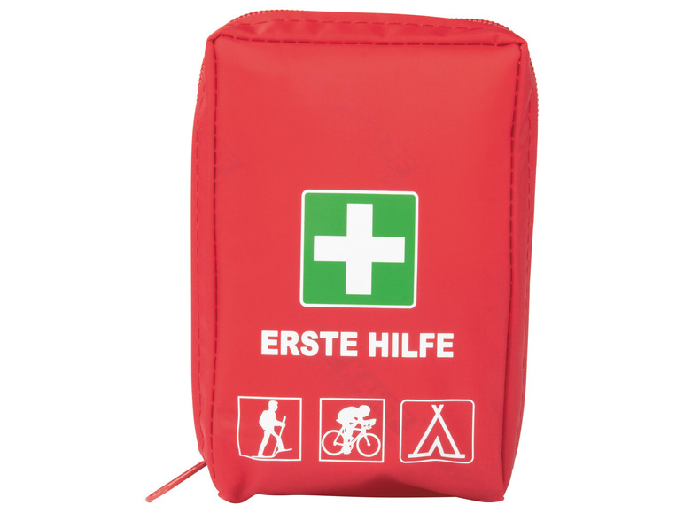 Rote Erste-Hilfe-Tasche mit weißem Kreuz auf grünem Hintergrund.