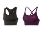 Zwei Sport-BHs: ein schwarzer mit Mesh und ein lilafarbener mit Print.