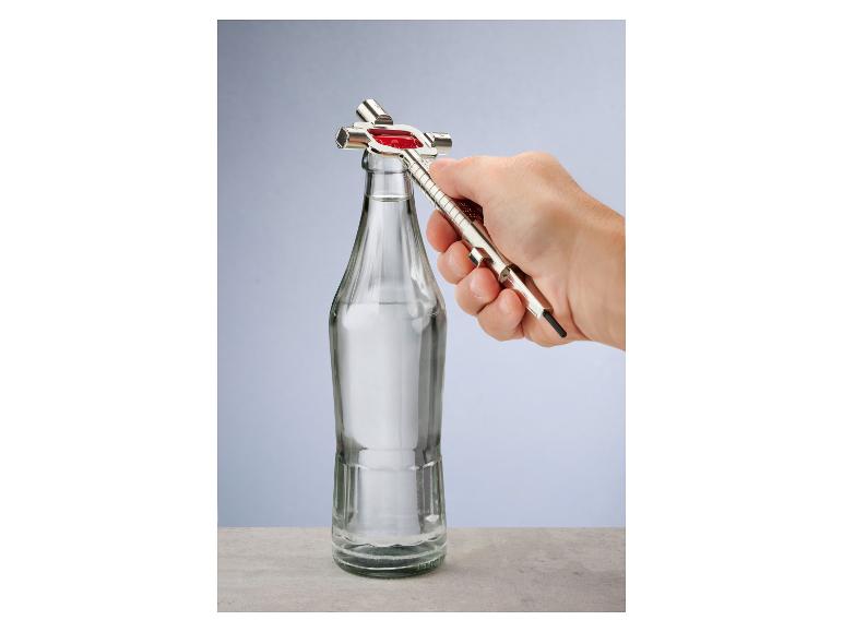 Eine Hand öffnet eine Glasflasche mit einem Metallflaschenöffner.
