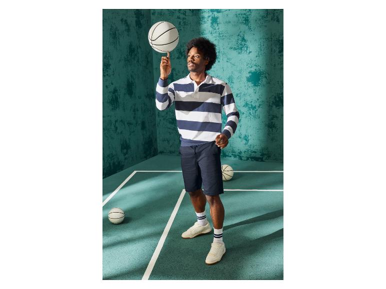 Mann in einem blau-weiß gestreiften Rugbyshirt der Marke ESMARA MEN.
